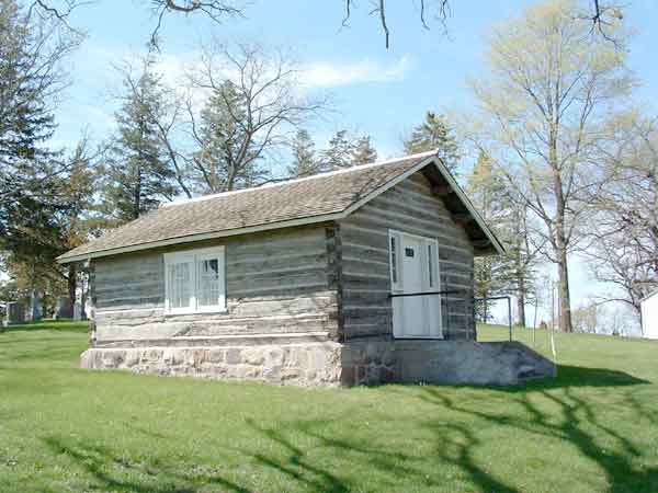 Photo of the log cabin in the spring.