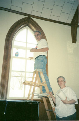 A couple from our church cleaning a church window.