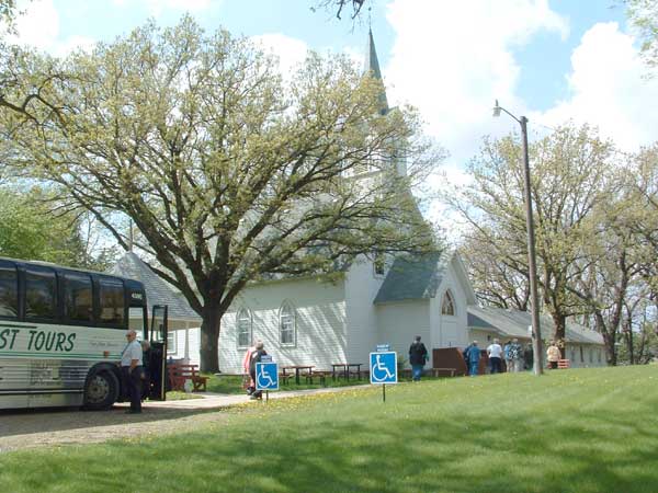 Bus passengers enter Nora UU Church.