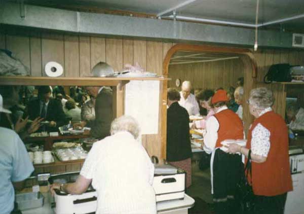 Photo of many people working at our smorgasbord.